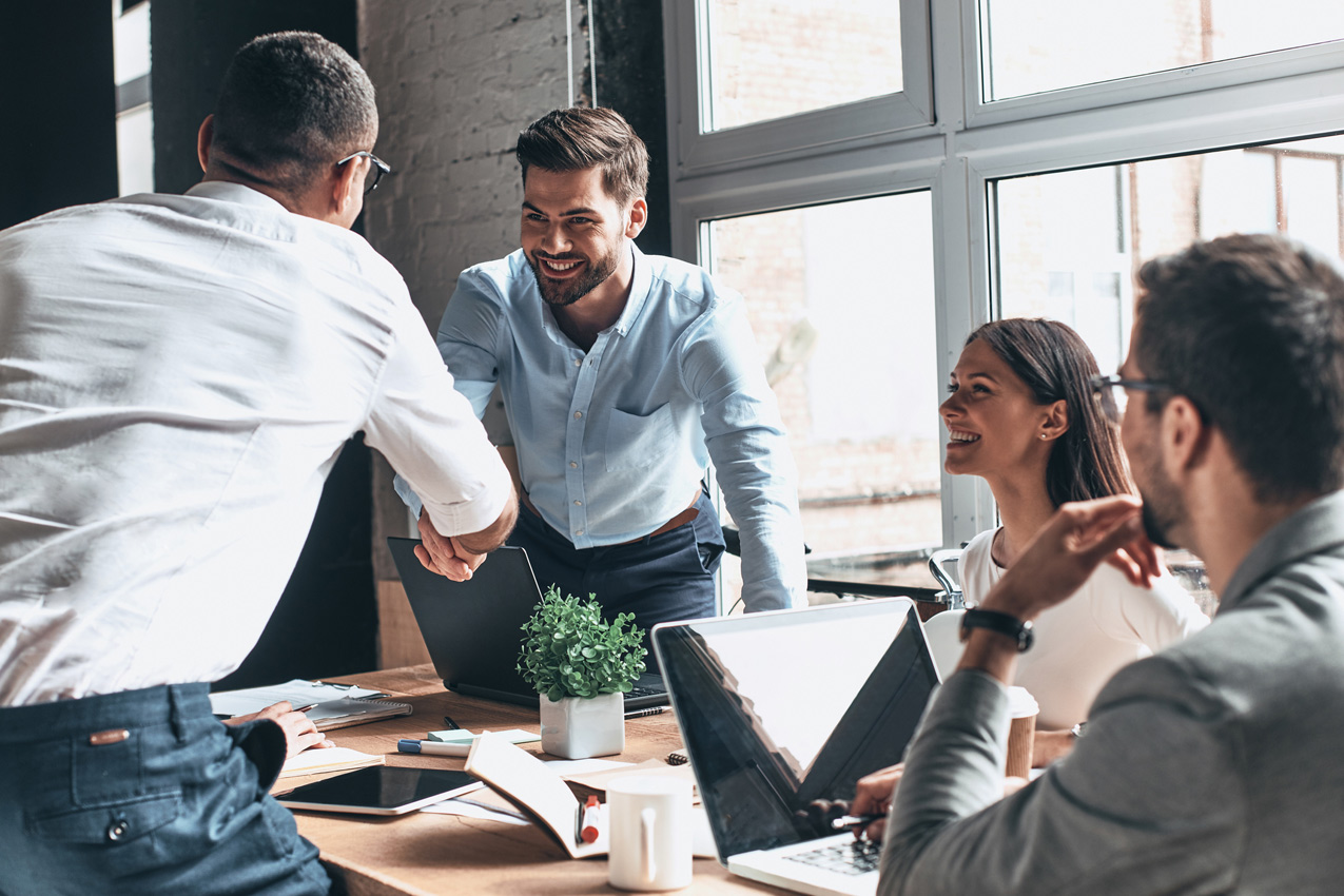 four happy people in a meeting